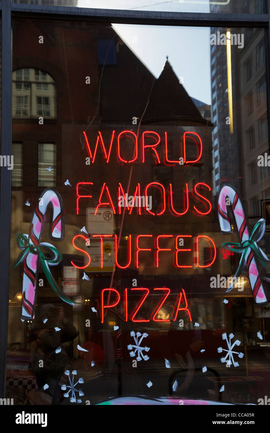 World Famous Stuffed Pizza sign Giordano's Restaurant and Pizzeria Chicago Illinois Window decorated for Christmas Stock Photo
