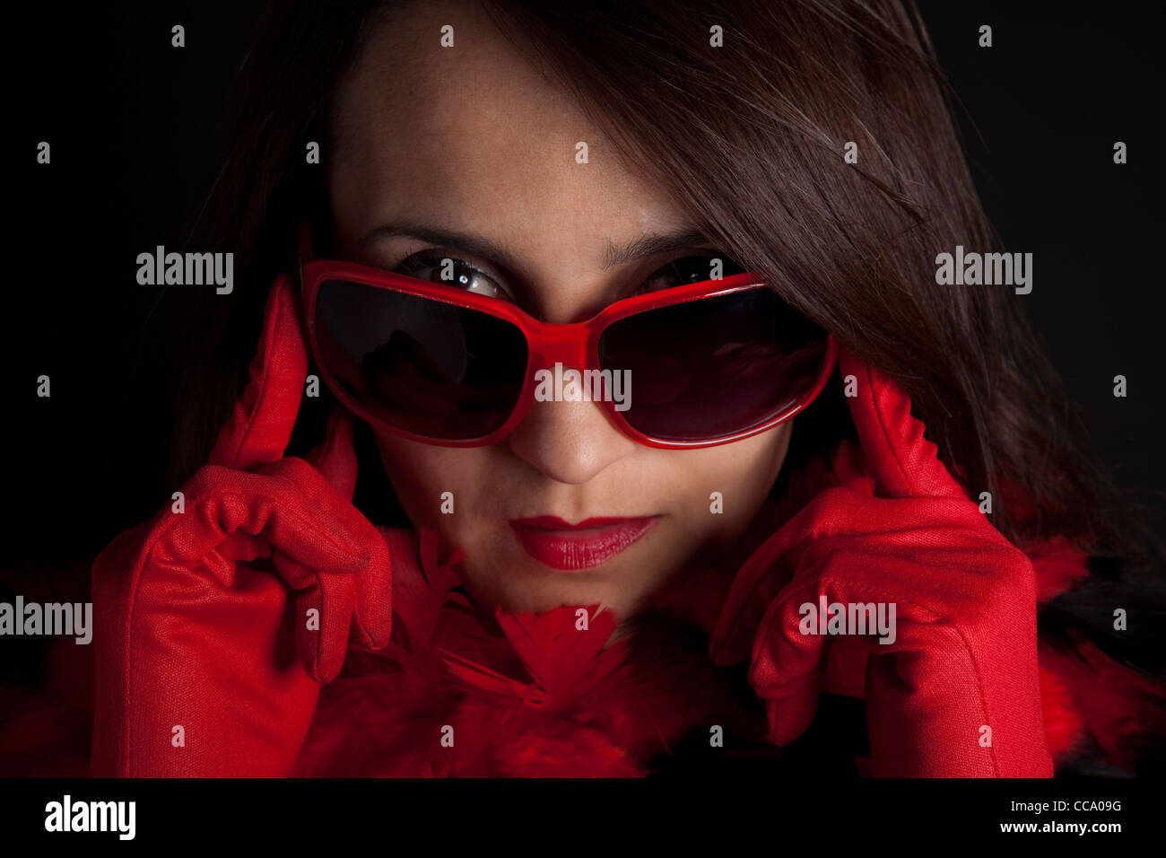 Close-up of lady in red wearing sunglasses. Stock Photo