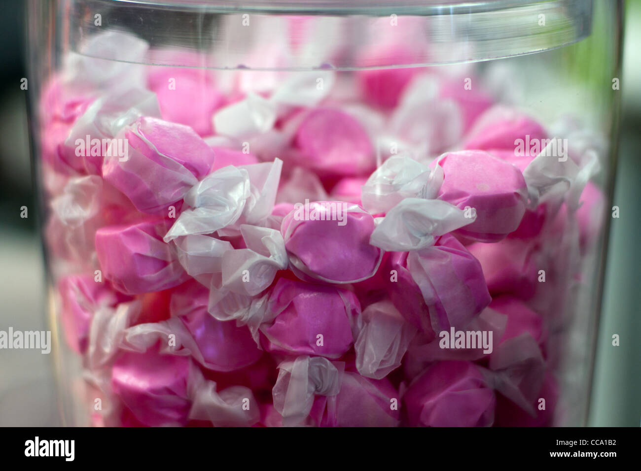 Pink wrapped Saltwater candy in glass container Stock Photo Alamy
