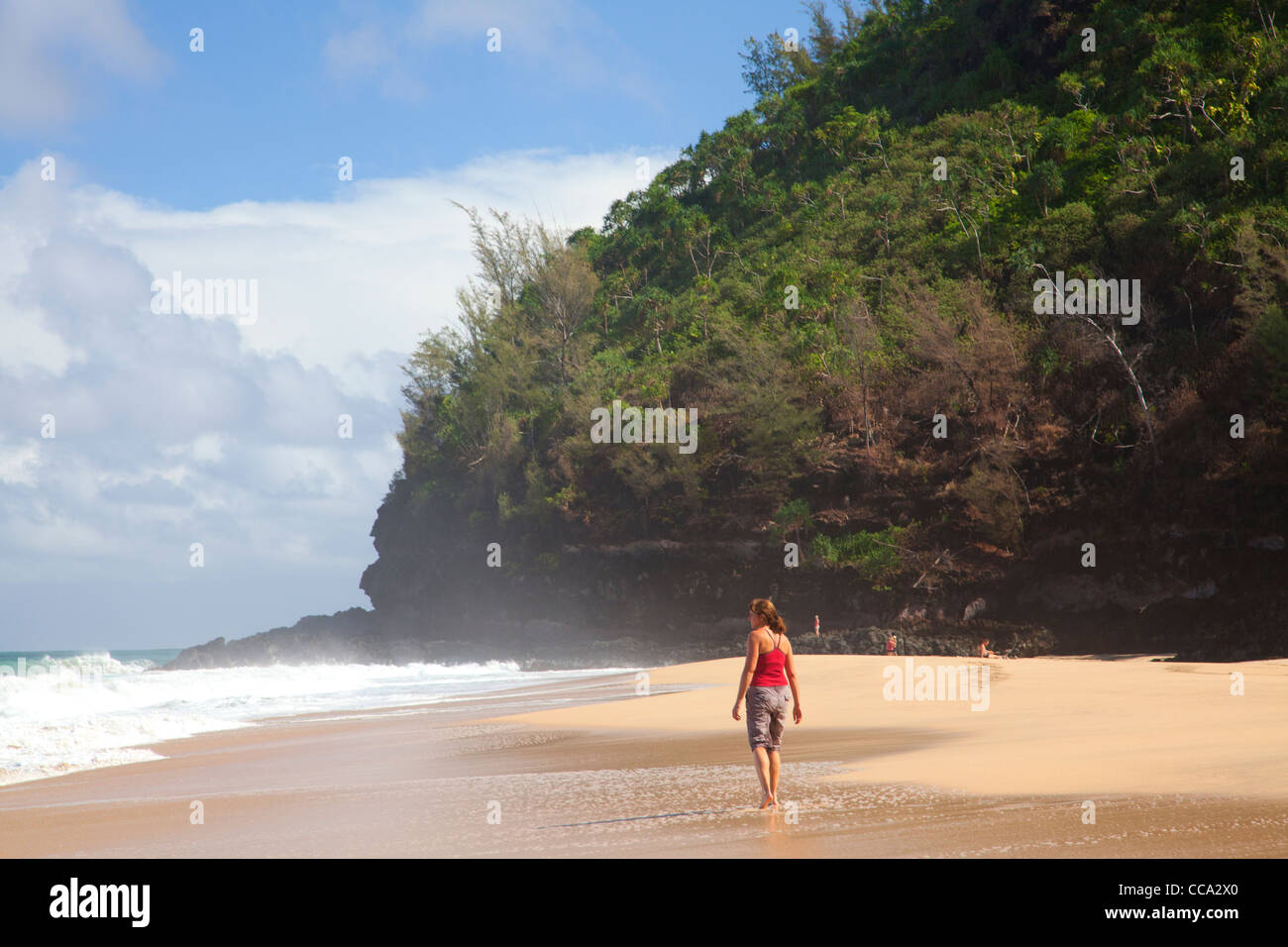 Hiker at Hanakapi'ai Beach along the Kalalau Trail, Na Pali Coast, Kauai, Hawaii. (Model Released) Stock Photo