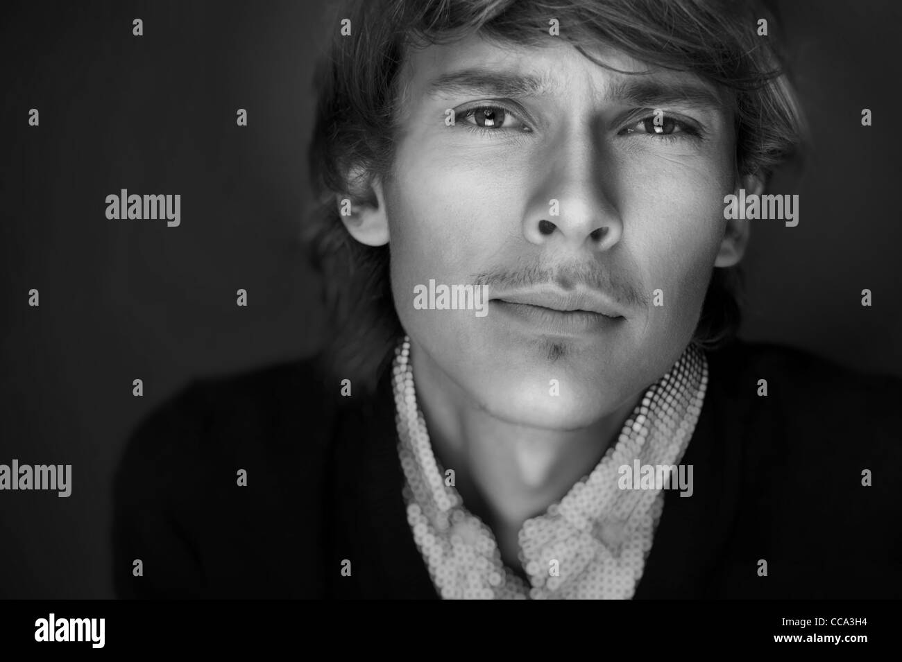 Portrait of young man with smart and wise look. Looking at camera. Black and white photo Stock Photo