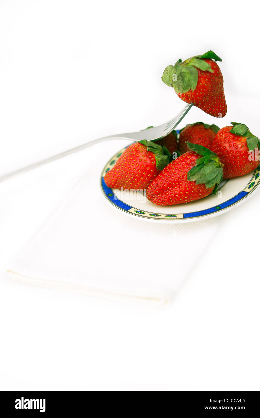 fresh strawberries on little dish isolated over white Stock Photo - Alamy