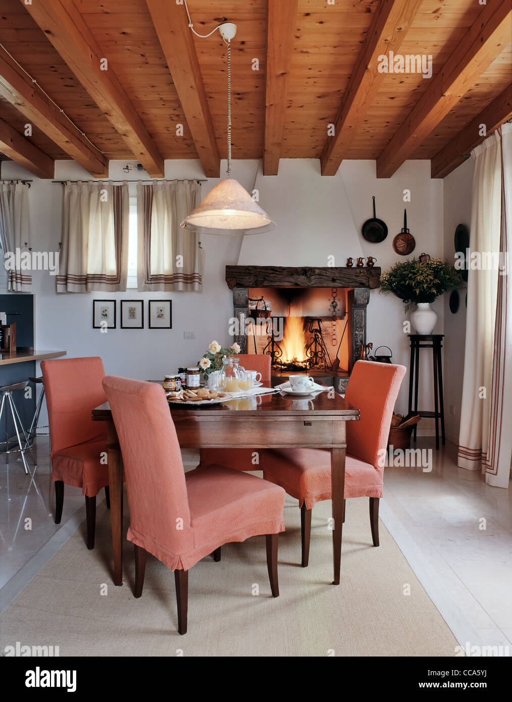 rustic interior, old dining table prepared for breakfast, carpet , wood