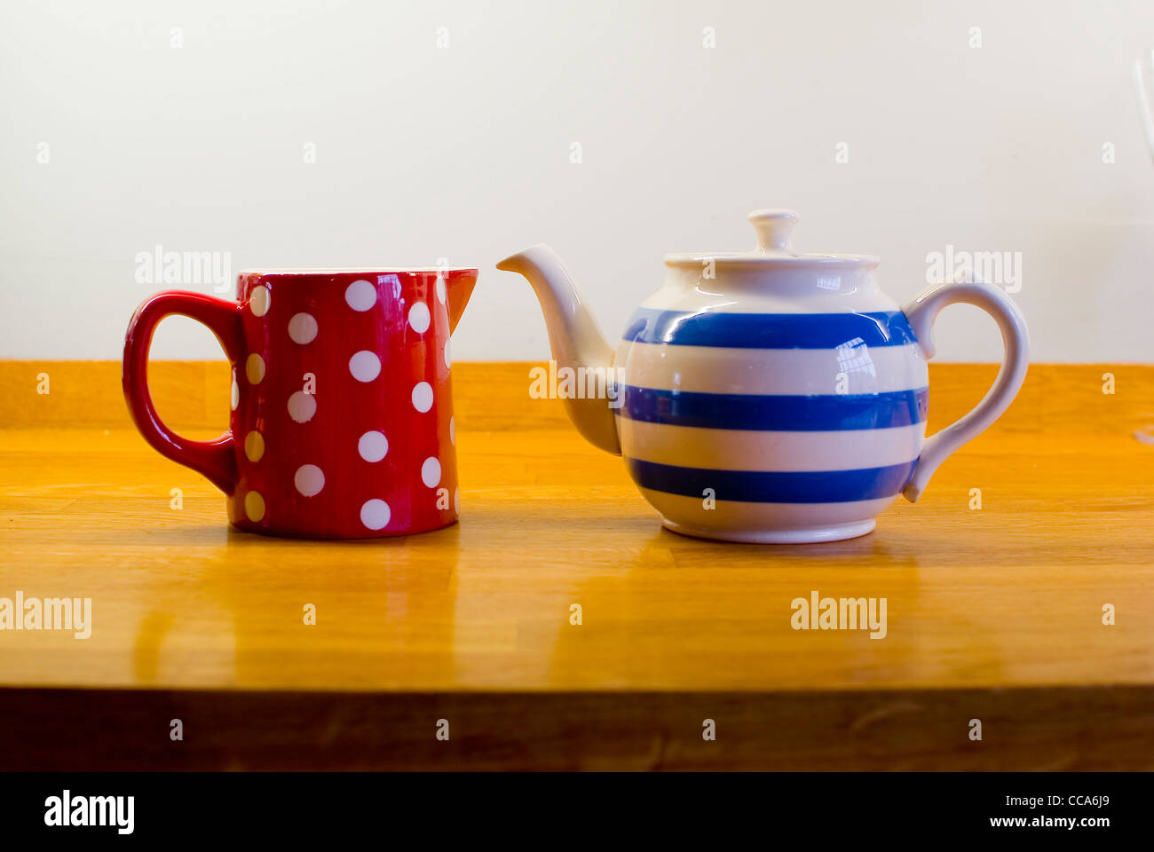 Teapot facing a milk jug Stock Photo Alamy