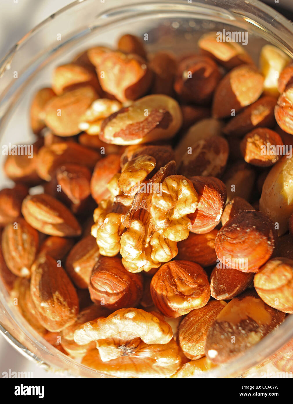 Healthy eating Mixed nuts including walnuts hazelnuts almonds and Brazils in a jar Stock Photo
