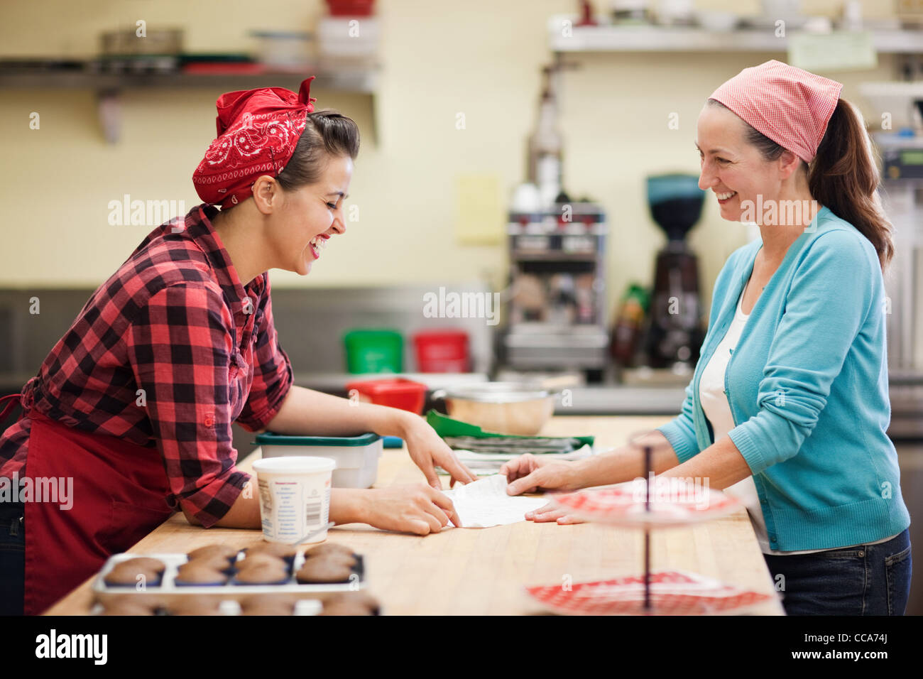 Women working together in commercial kitchen Stock Photo
