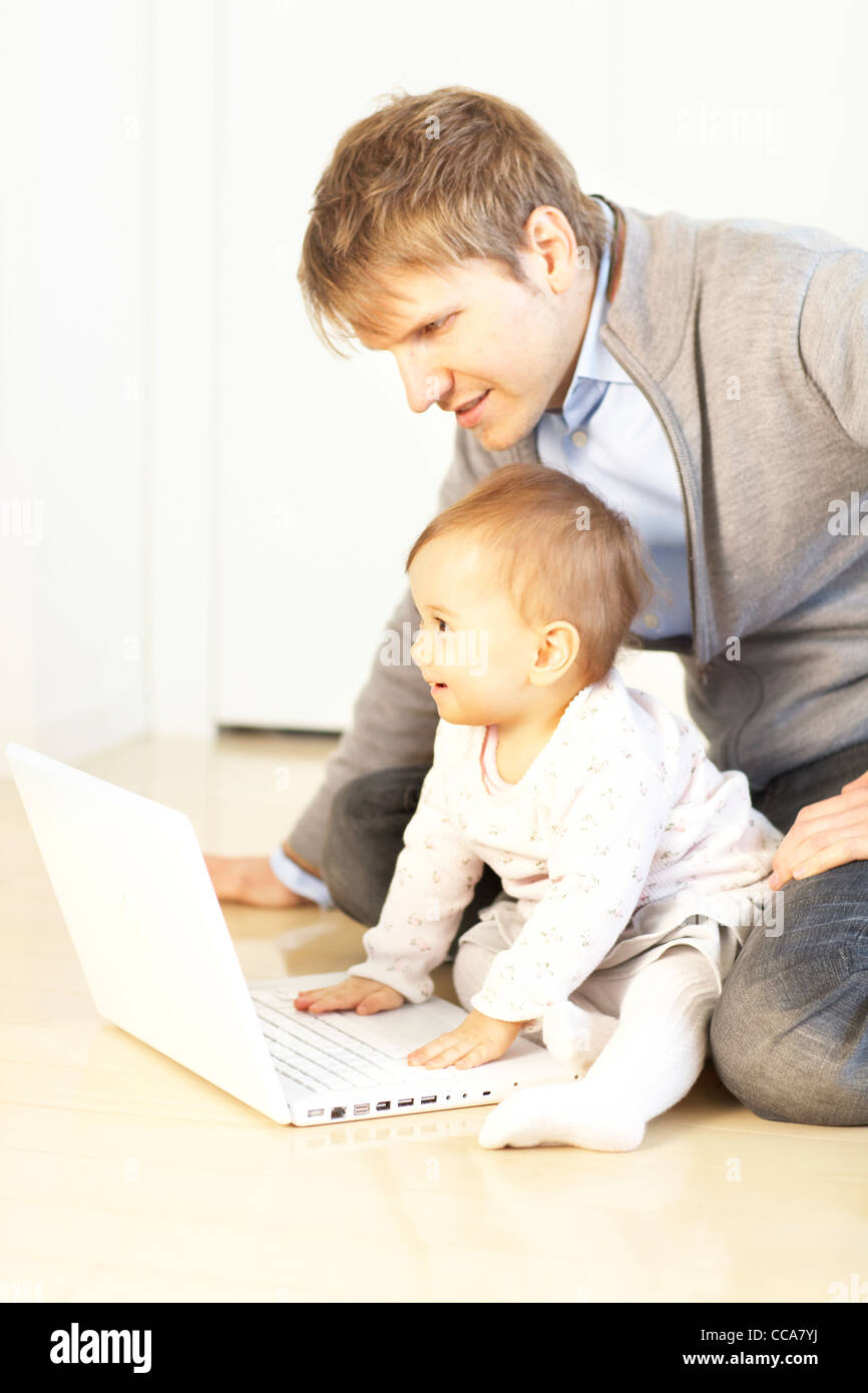 Father and Baby Girl Using Laptop Stock Photo - Alamy