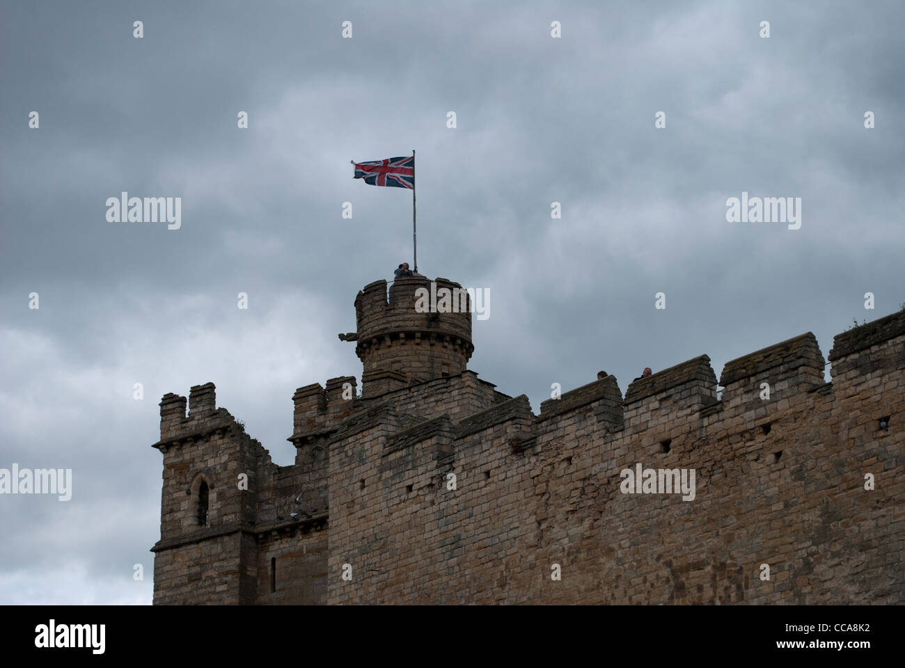 Tower and castle wall near East Gate of Lincoln Castle with cloudy sky Stock Photo