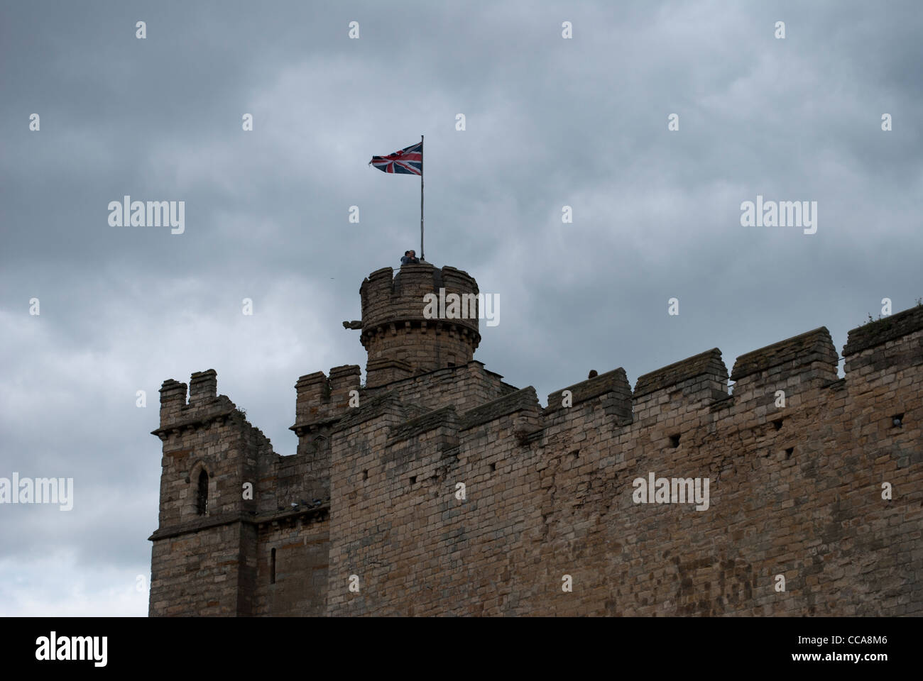 Tower and castle wall near East Gate of Lincoln Castle with cloudy sky Stock Photo
