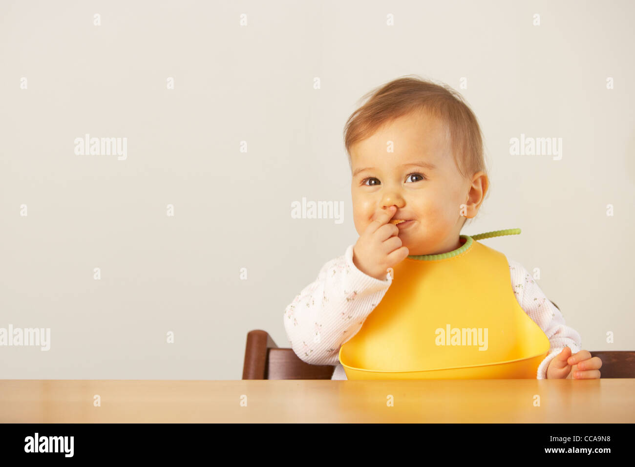Baby Girl Eating with Hand Stock Photo Alamy
