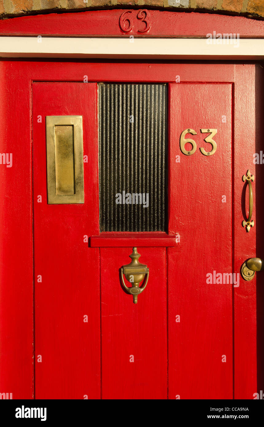 Brass fittings on a red painted front door in Great Missenden Bucks UK