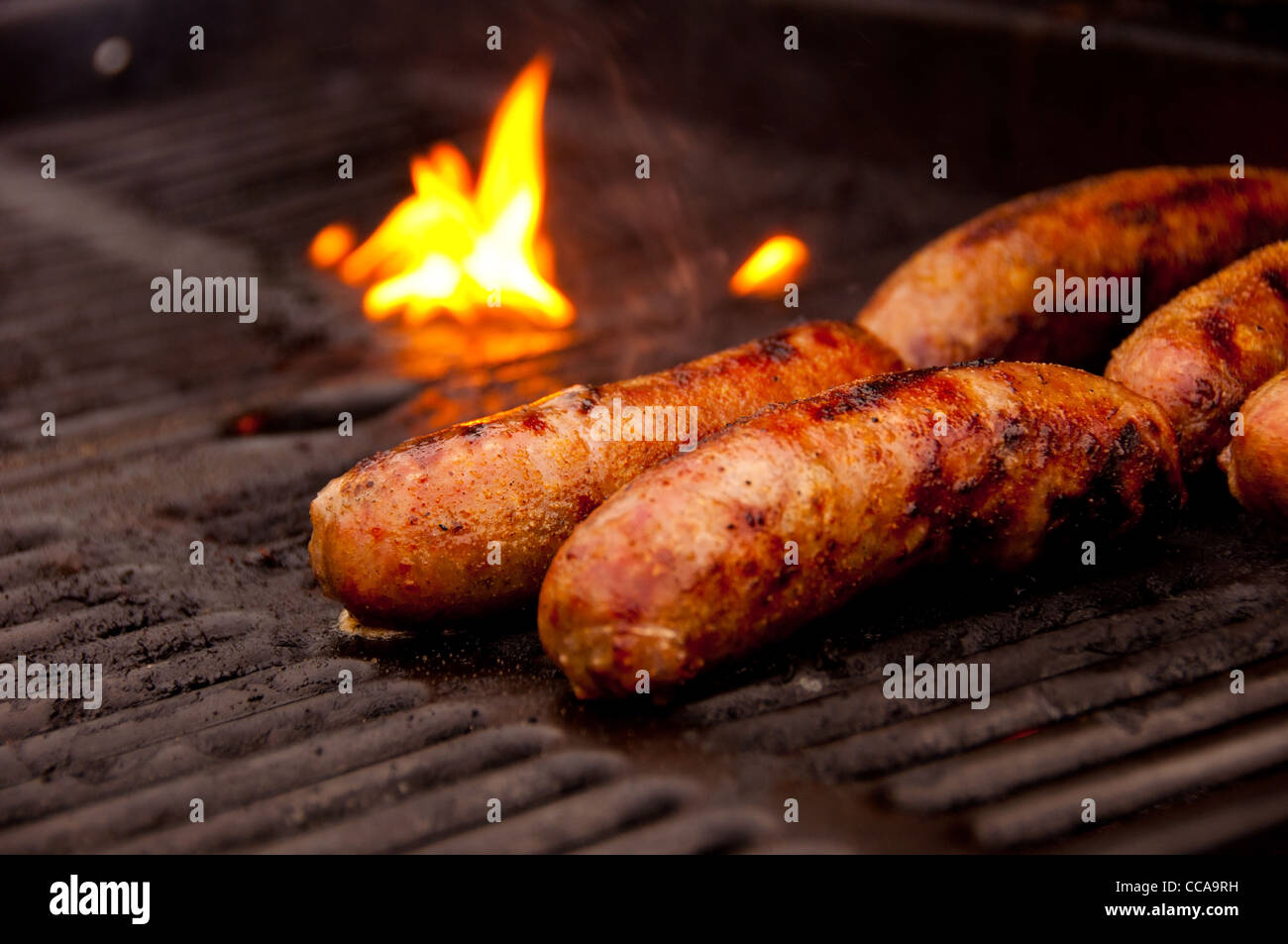 Multiple Brats on an Open Grill with a black grate Stock Photo