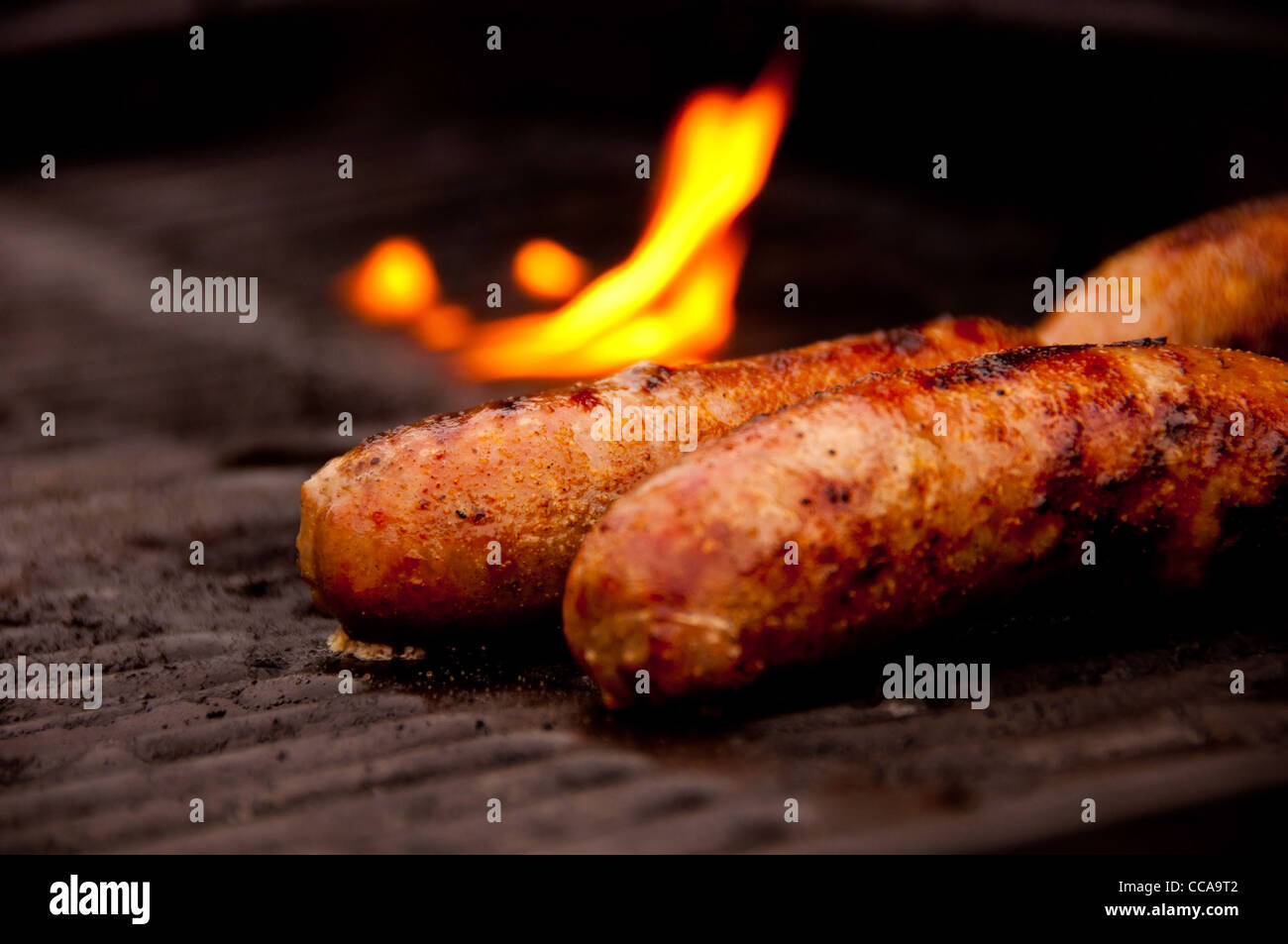 Multiple Brats on an Open Grill with a black grate Stock Photo Alamy