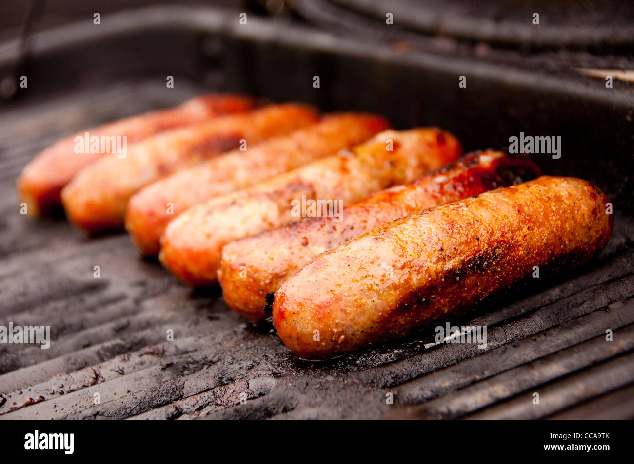 Multiple Brats on an Open Grill with a black grate Stock Photo Alamy