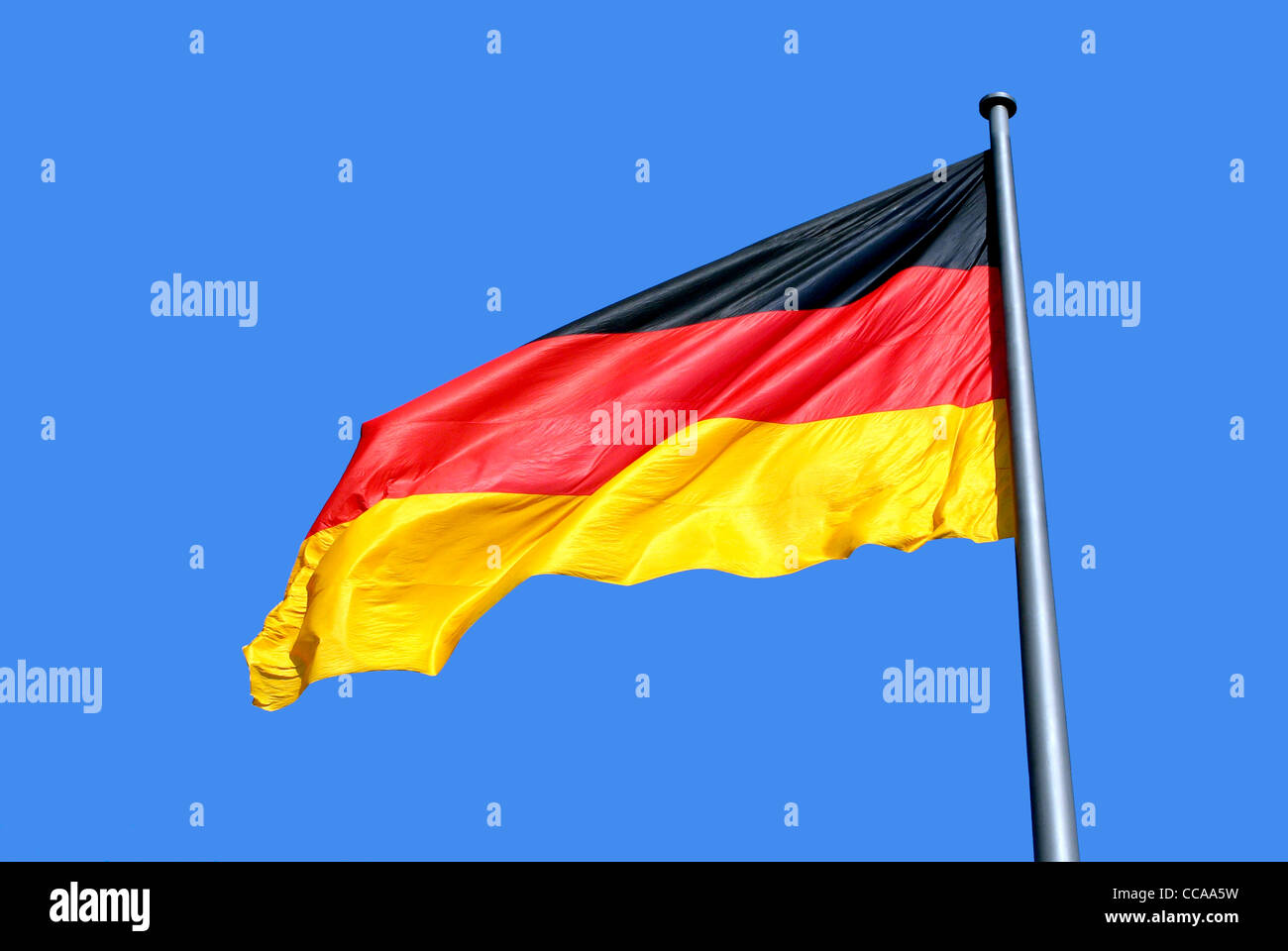 German national flag in front of blue sky in Berlin. Stock Photo