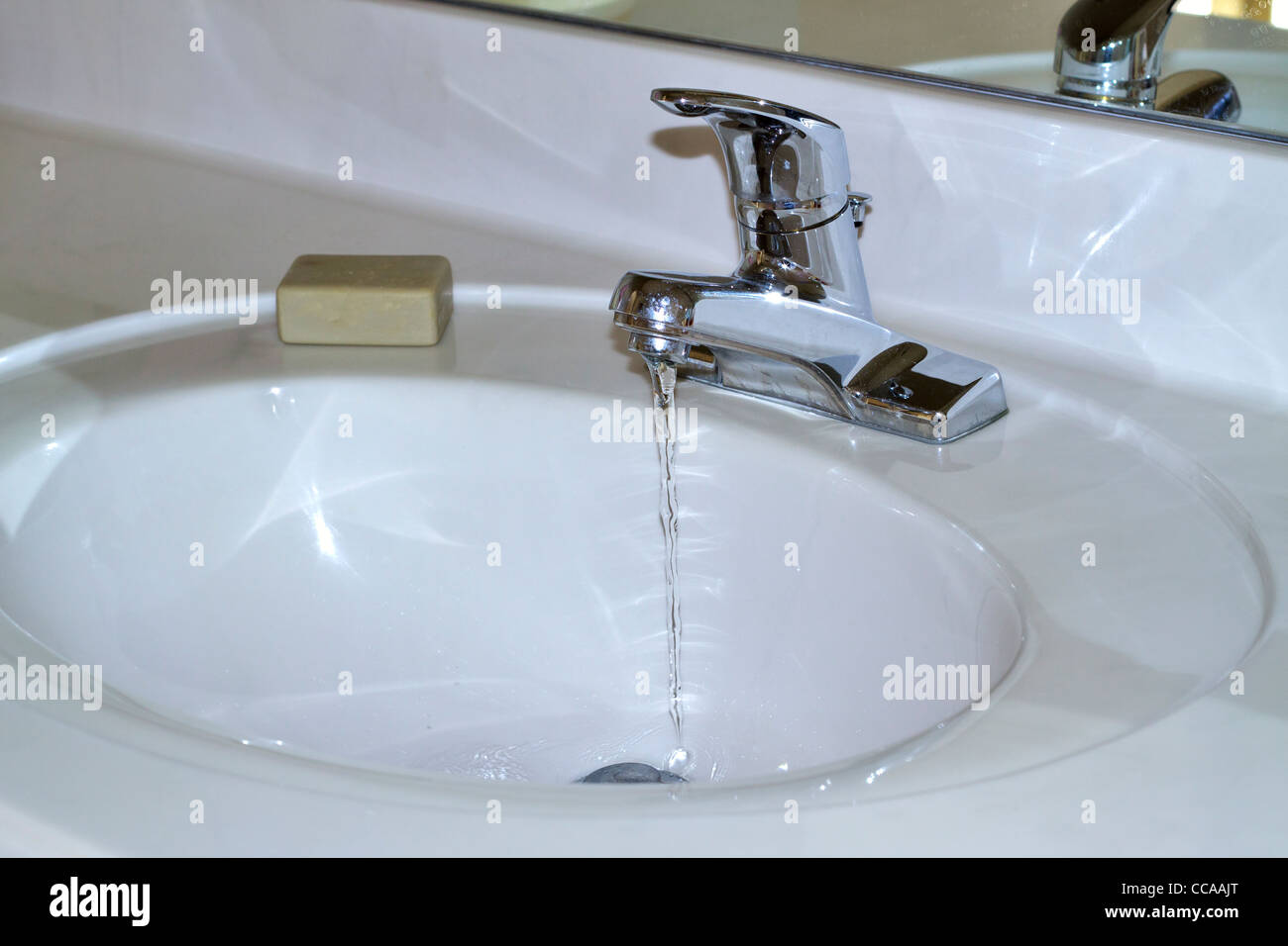 Bathroom sink with tap running Stock Photo