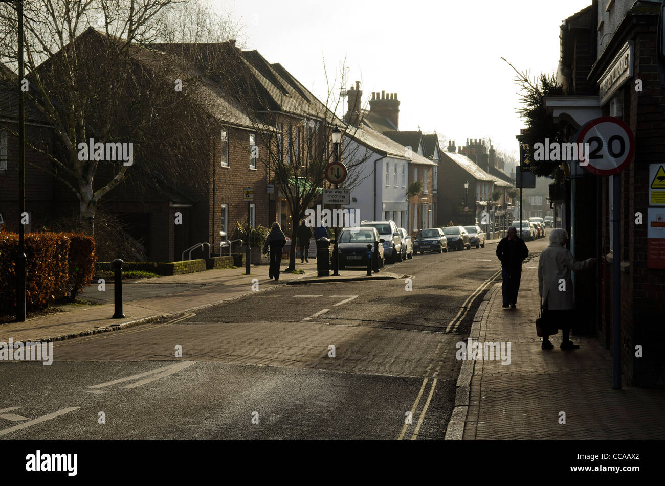 A few pedestrians, shoppers and parked cars in High street Great Missenden Bucks UK Stock Photo