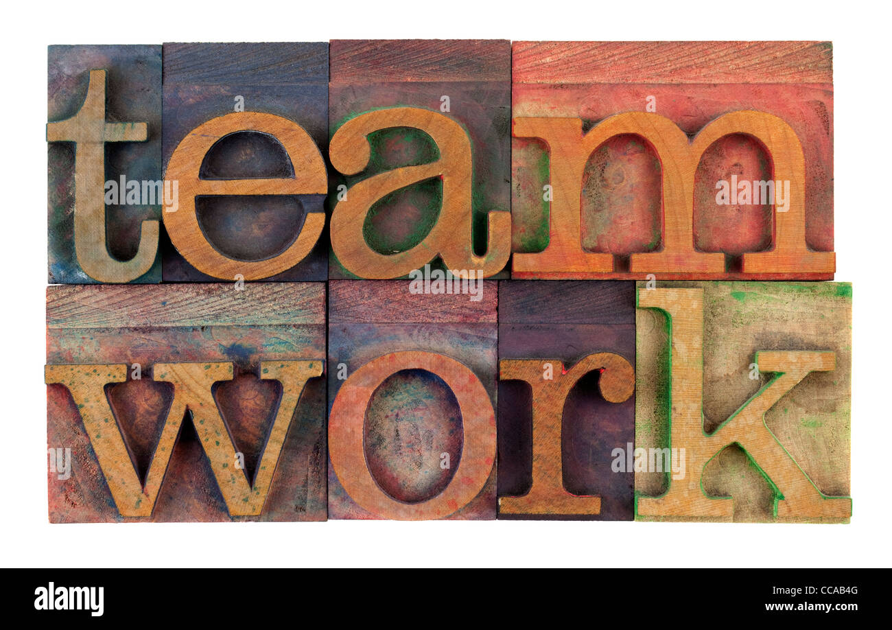the word teamwork in vintage wooden letterpress type, stained by colorful inks, isolated on white Stock Photo