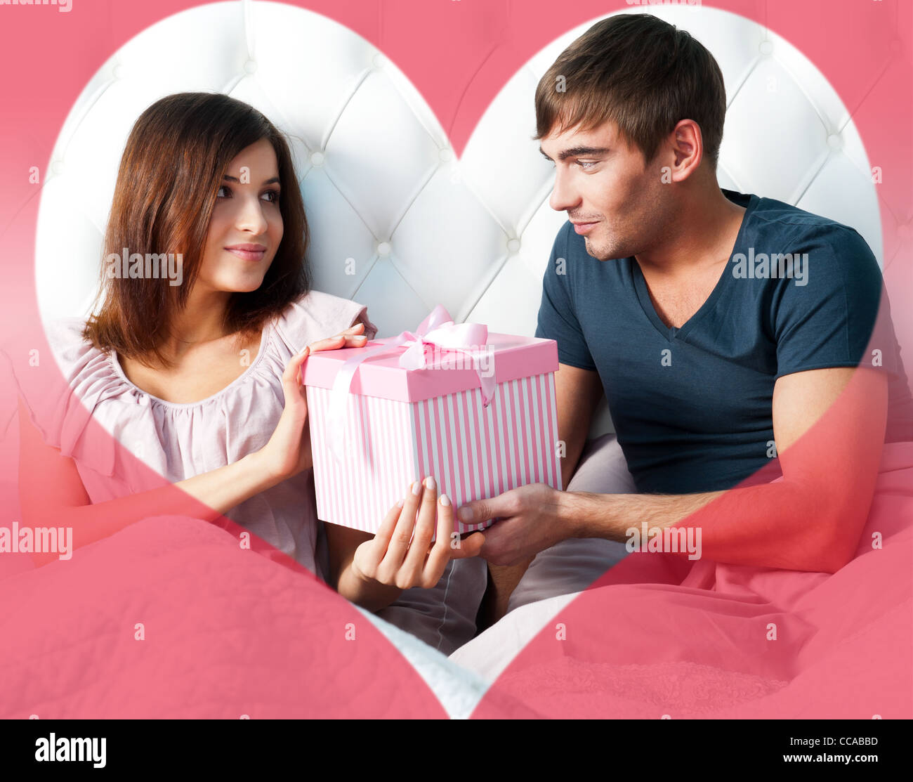 Closeup Portrait of a happy young couple relaxing on the bed. Man ...