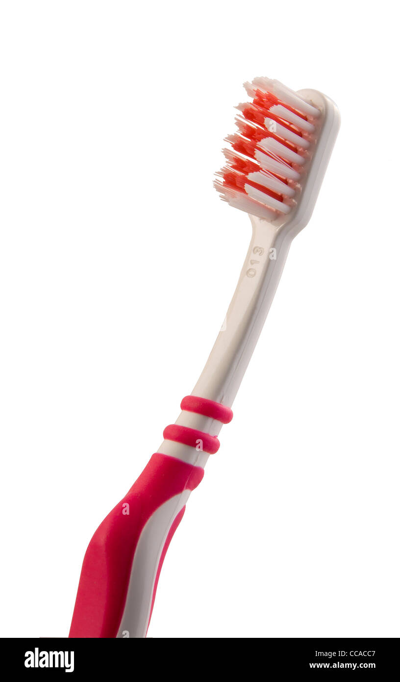 red and white toothbrush on a white background Stock Photo