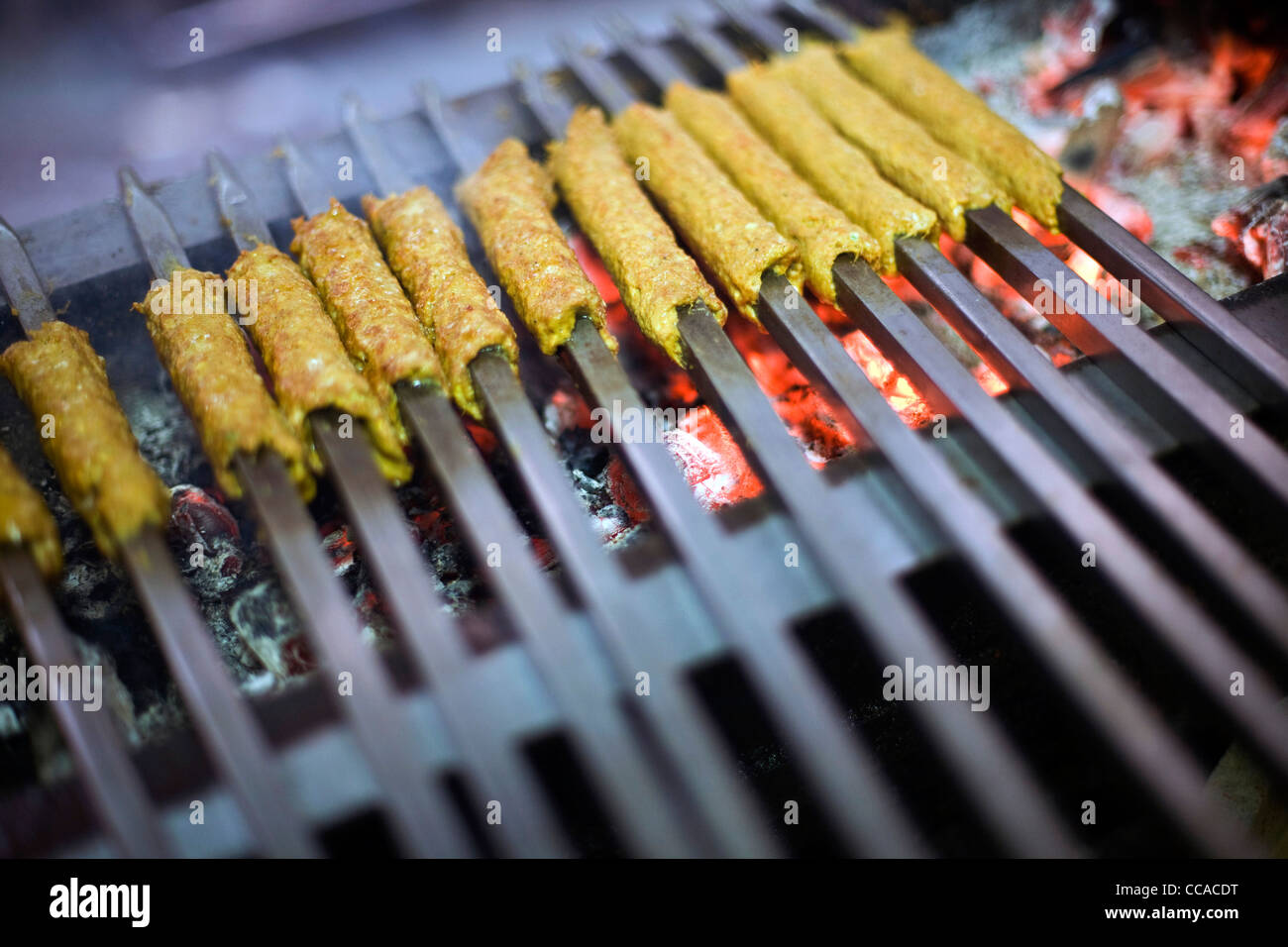 Kebabs cooking on a griddle at Karim's Restaurant, Delhi, India Stock Photo
