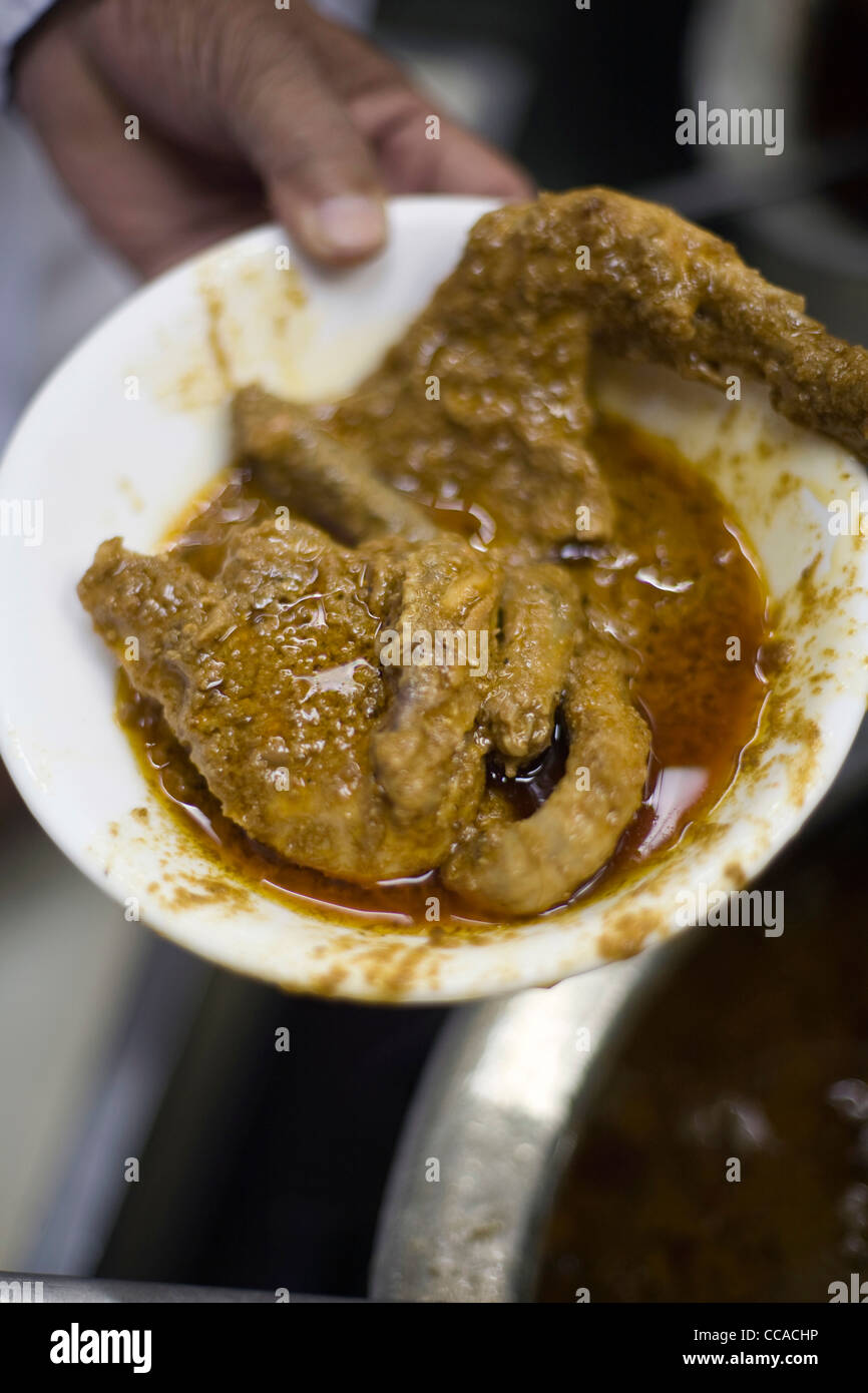 A plate of chicken curry at Karim's Restaurant Delhi, India Stock Photo