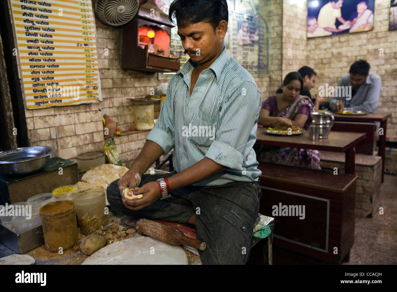 Ram Billas making paratha at Parawthe Wala restaurant in Old Delhi, India Stock Photo