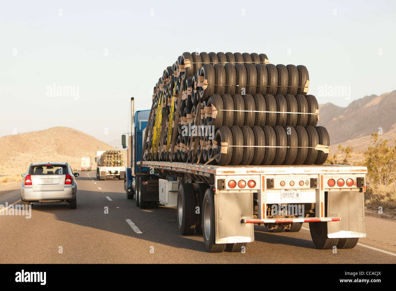 Tractor trailer carrying new tires Stock Photo Alamy