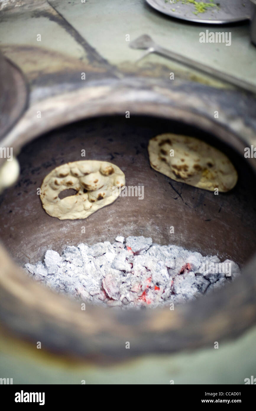 Chapati breads in the tandoor oven at the Village Restaurant in Siri Fort, New Delhi Stock Photo