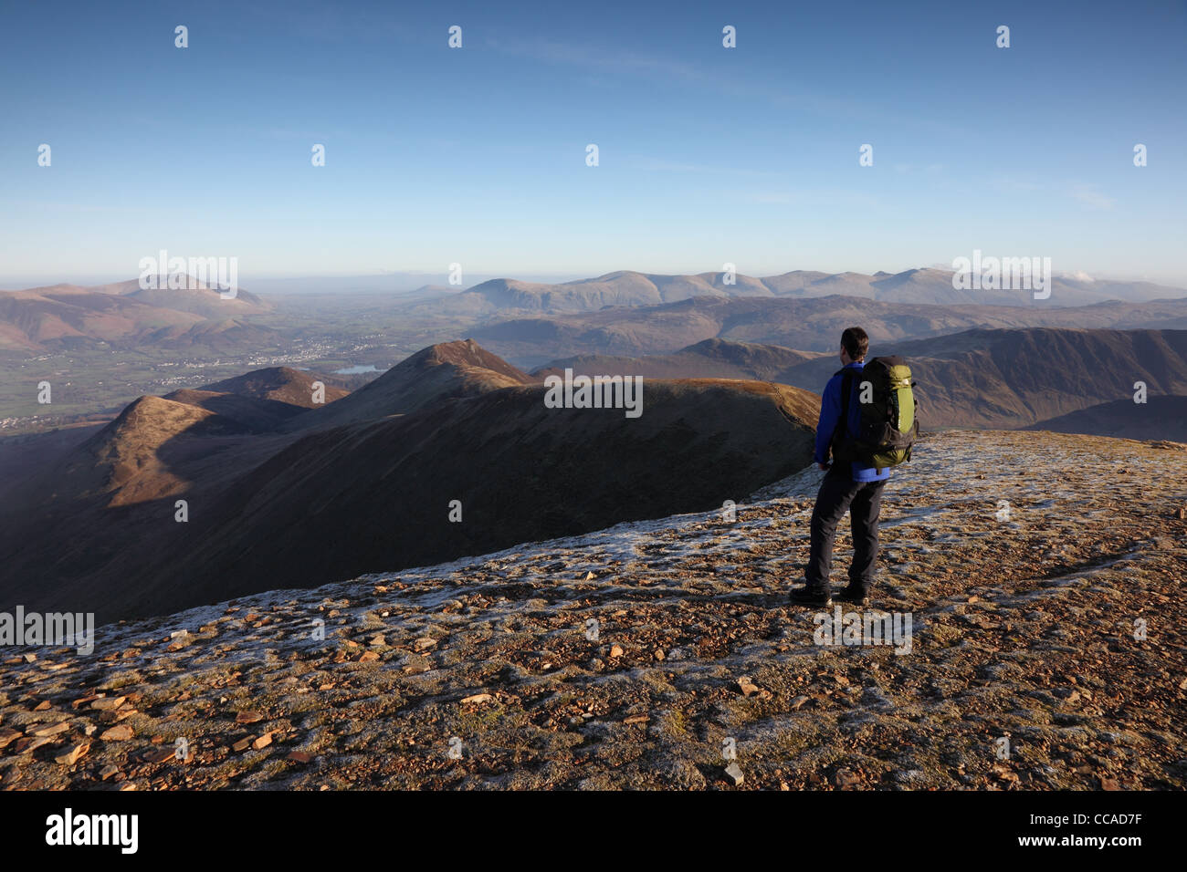 Walker and the Mountain of Causey Pike with the View Towards the Helvellyn Range from Summit of Crag Hill Lake District Cumbria Stock Photo