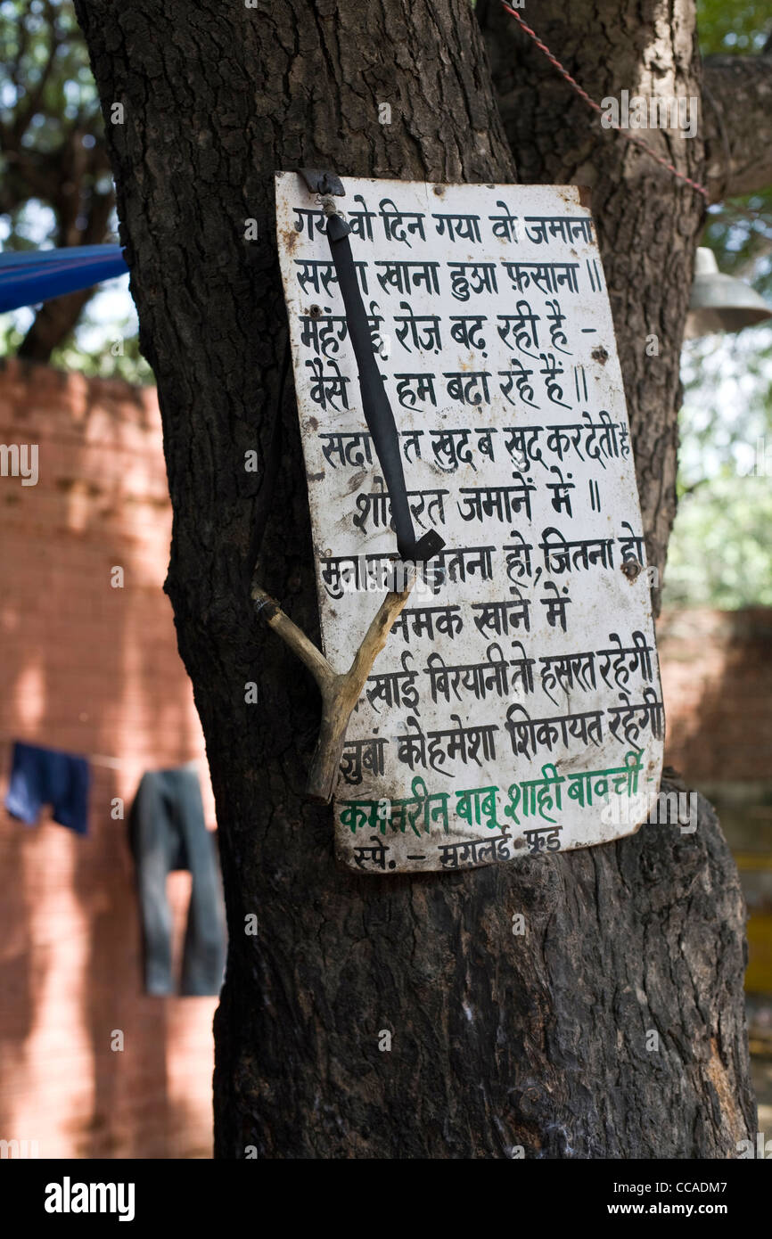 The menu and a catapult used for scaring birds outside Babu Shahi Bawarchi, New Delhi, India Stock Photo
