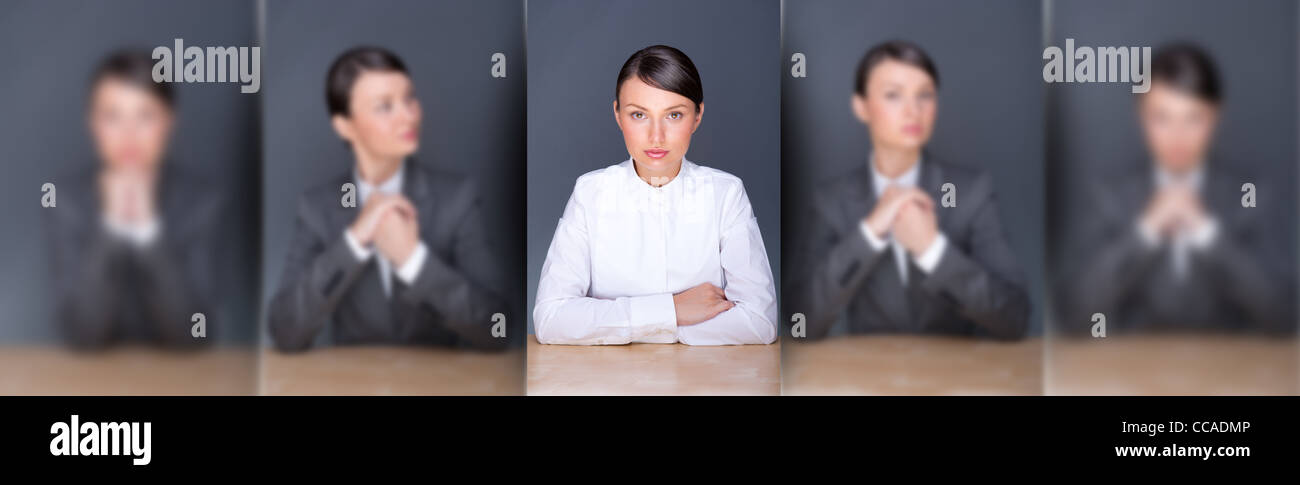 Collage of young leading employer in focus and her clones in blur in different poses Stock Photo