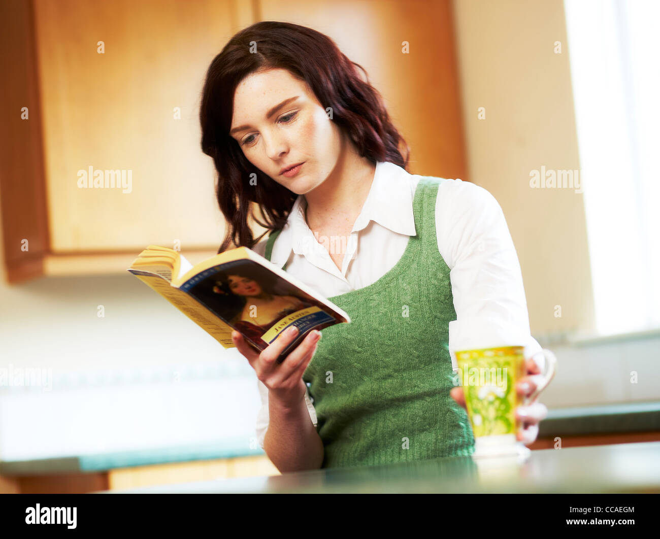 Woman sat reading a book Stock Photo