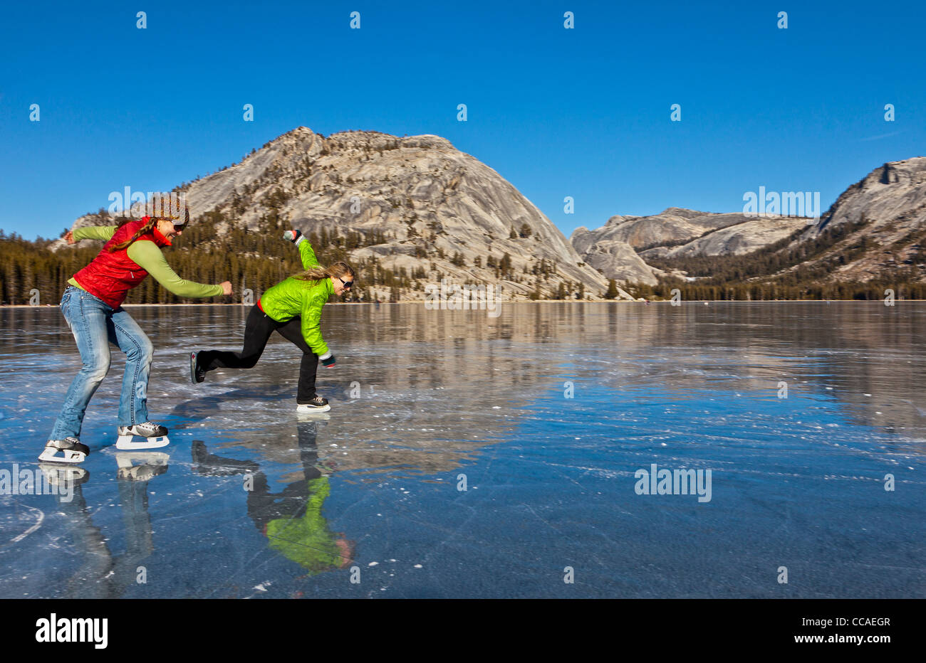 Ice skating on frozen Tenaya Lake in Yosemite National Park Stock Photo