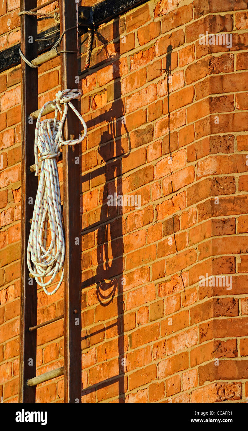 A reel of nylon rope used for climbing attached to a wooden ladder