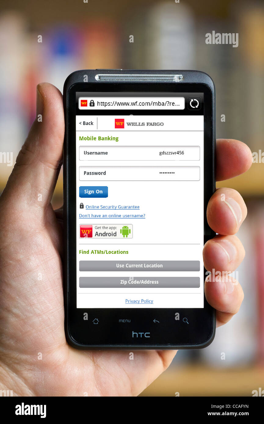 Logging on to online mobile banking with Wells Fargo Bank on an HTC smartphone Stock Photo