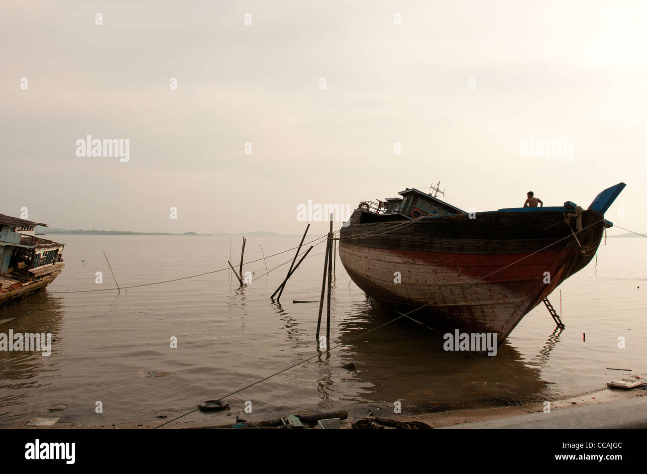 A boat during low tide in Karimun Stock Photo