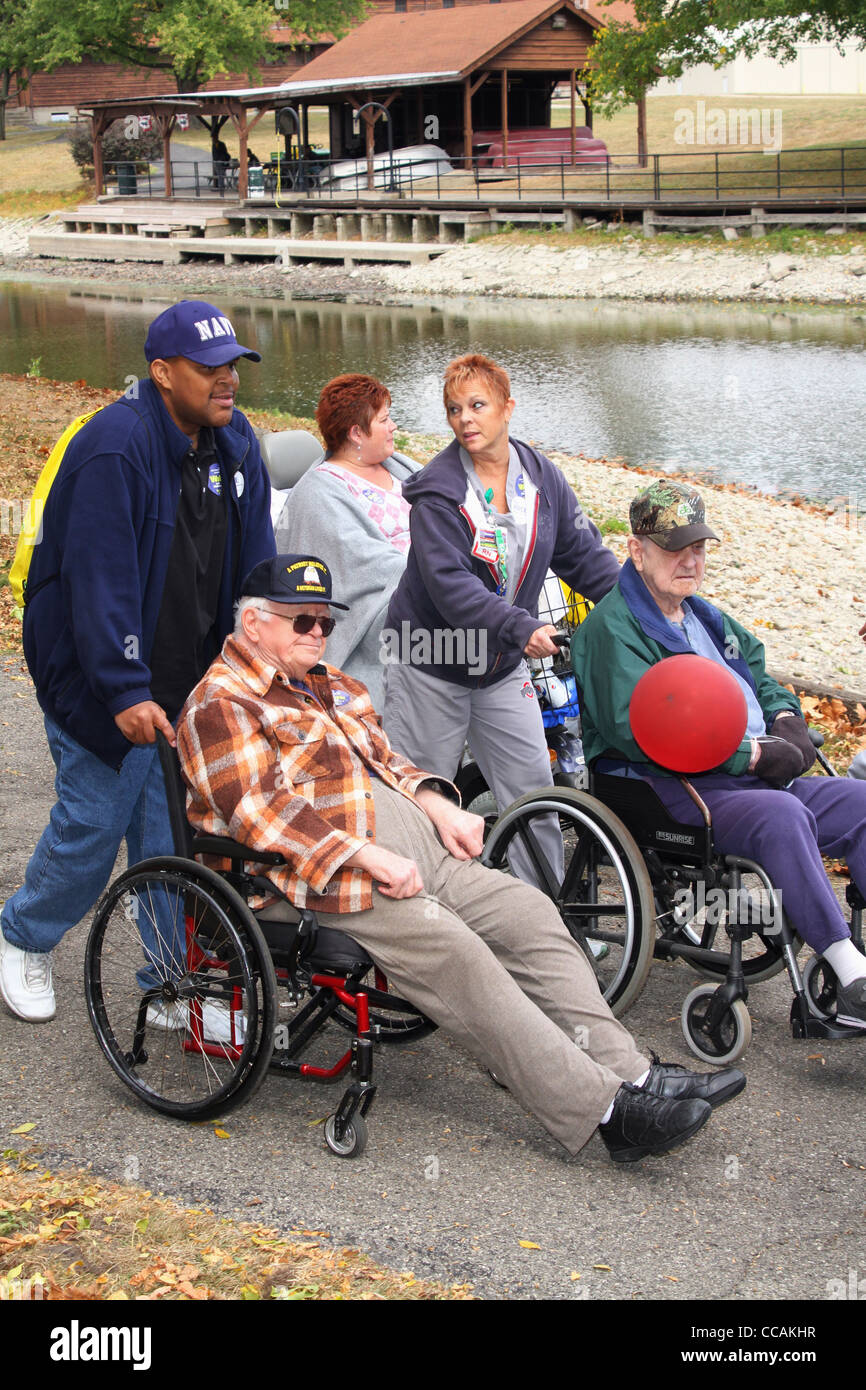 Elderly men in wheelchairs with nurse aids. Alzheimer's Memory Walk