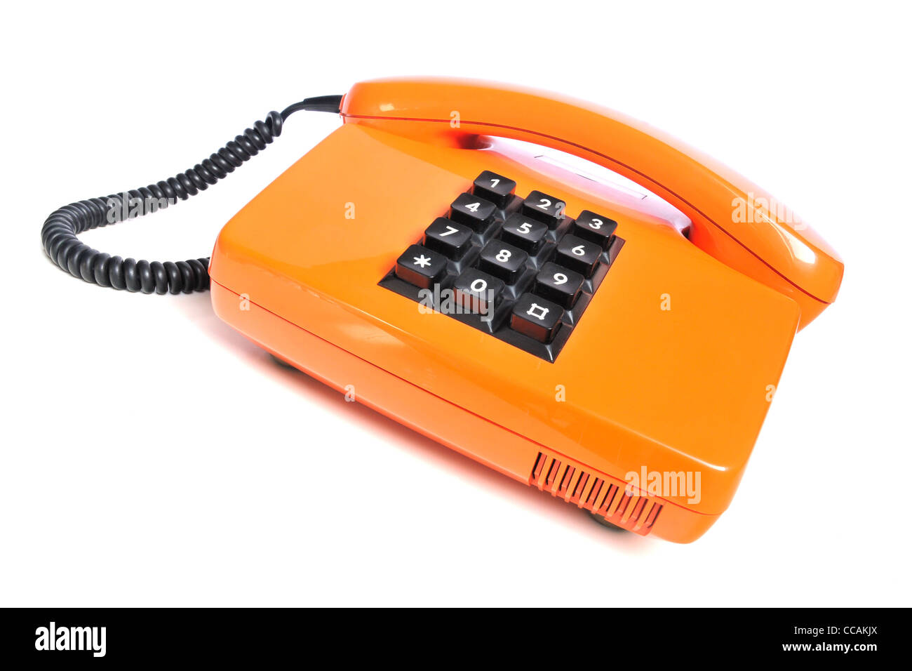 Orange colored retro telephone on white background Stock Photo Alamy