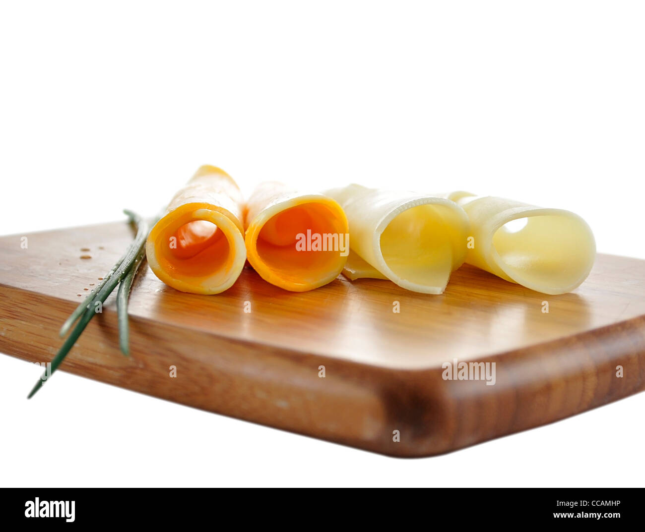 cheese slices on a cutting board Stock Photo