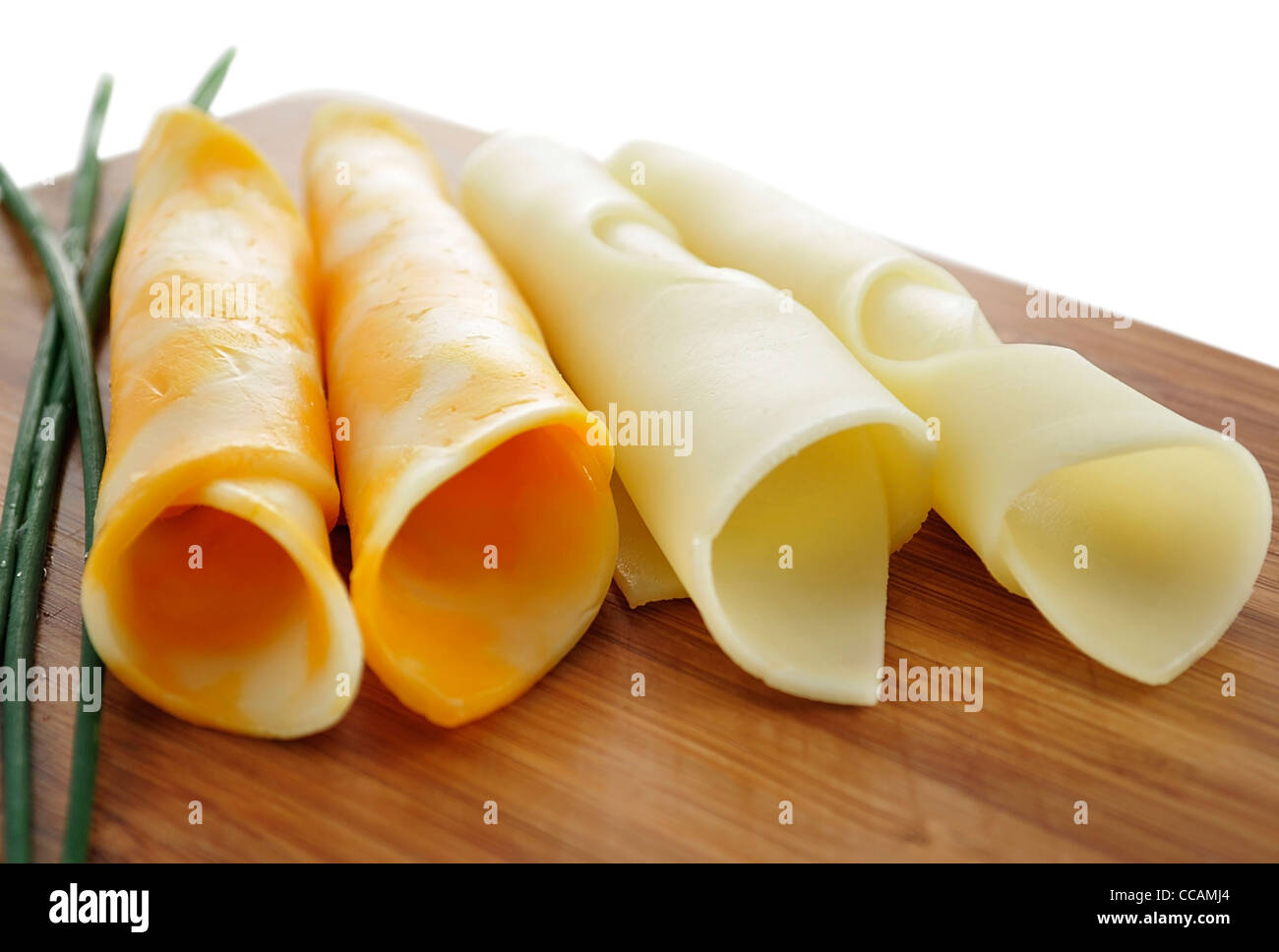 cheese slices on a cutting board, close up Stock Photo