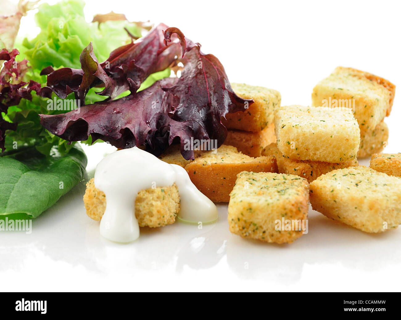 seasoned croutons and salad leaves , close up Stock Photo