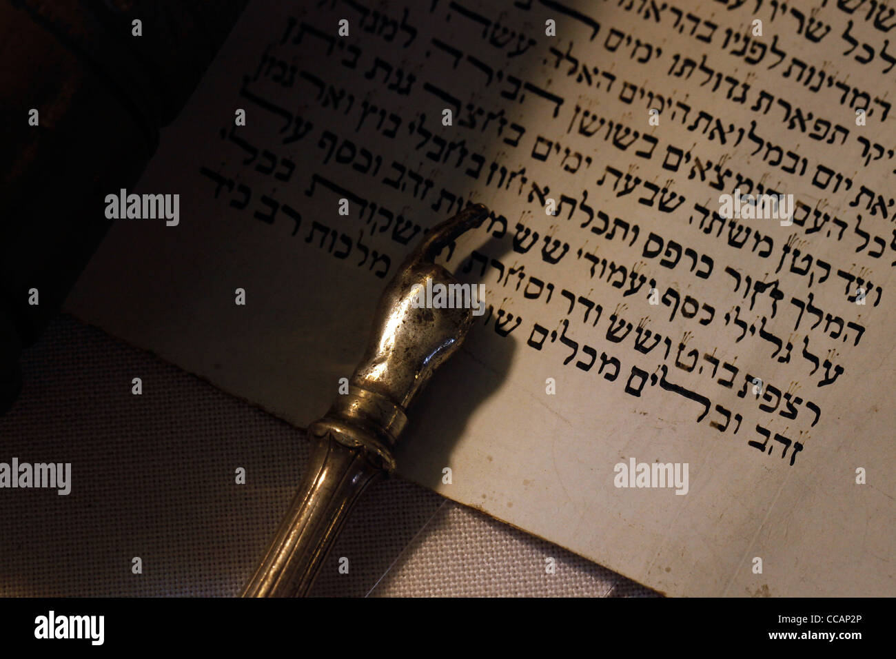 A silver Yad Jewish ritual pointer, popularly known as a Torah pointer, used by the reader to follow the text during the Torah reading from the parchment Torah scrolls Stock Photo