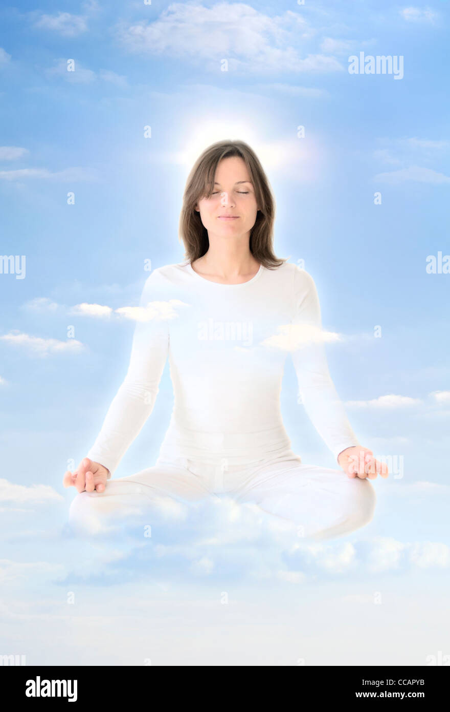 Download this stock image: Beautiful young girl meditating levitating in th...