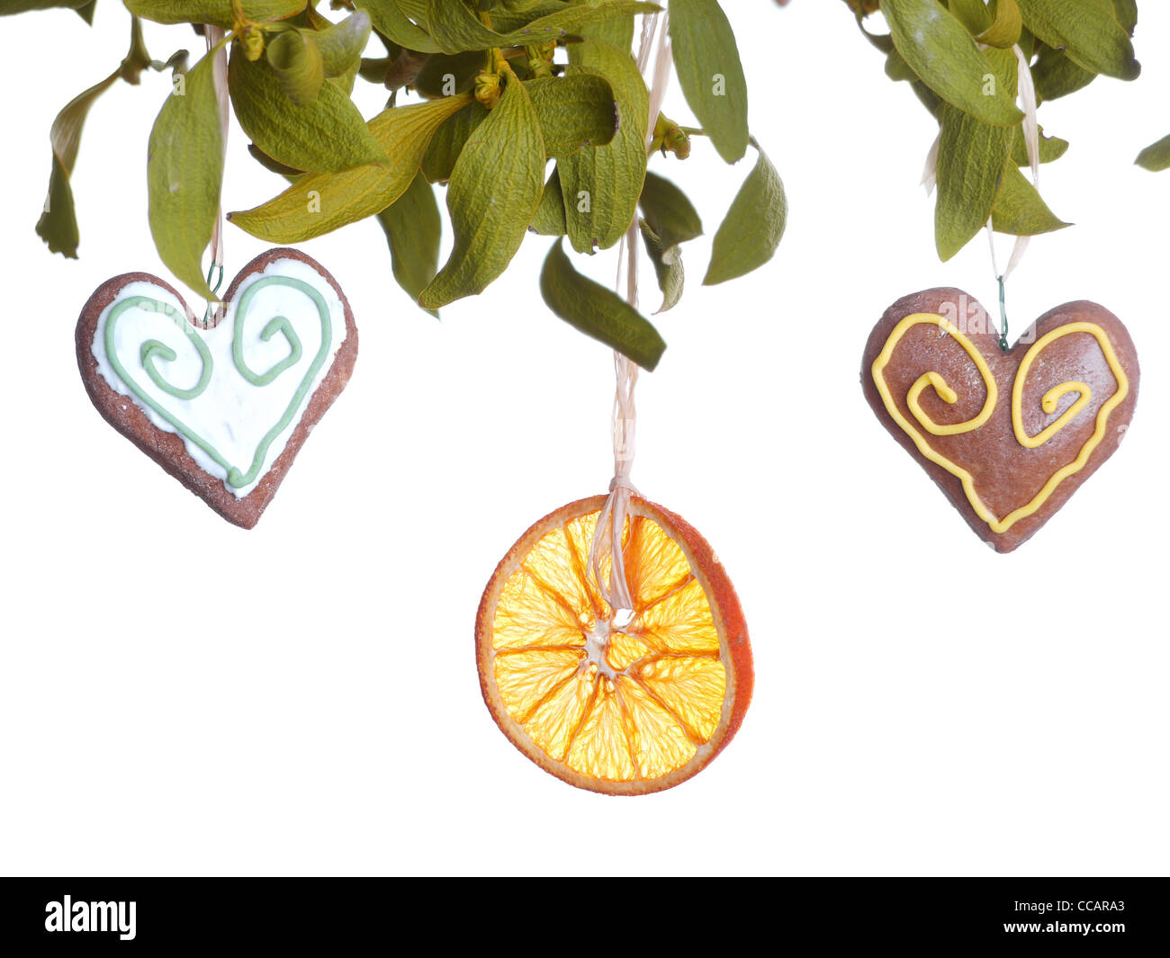 Mistletoe with two gingerbread heart cakes and dried orange slice Stock Photo