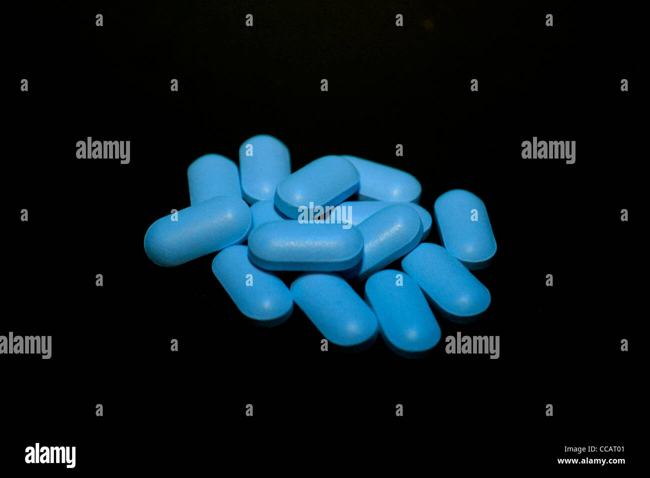 Blue pills over a black background Stock Photo