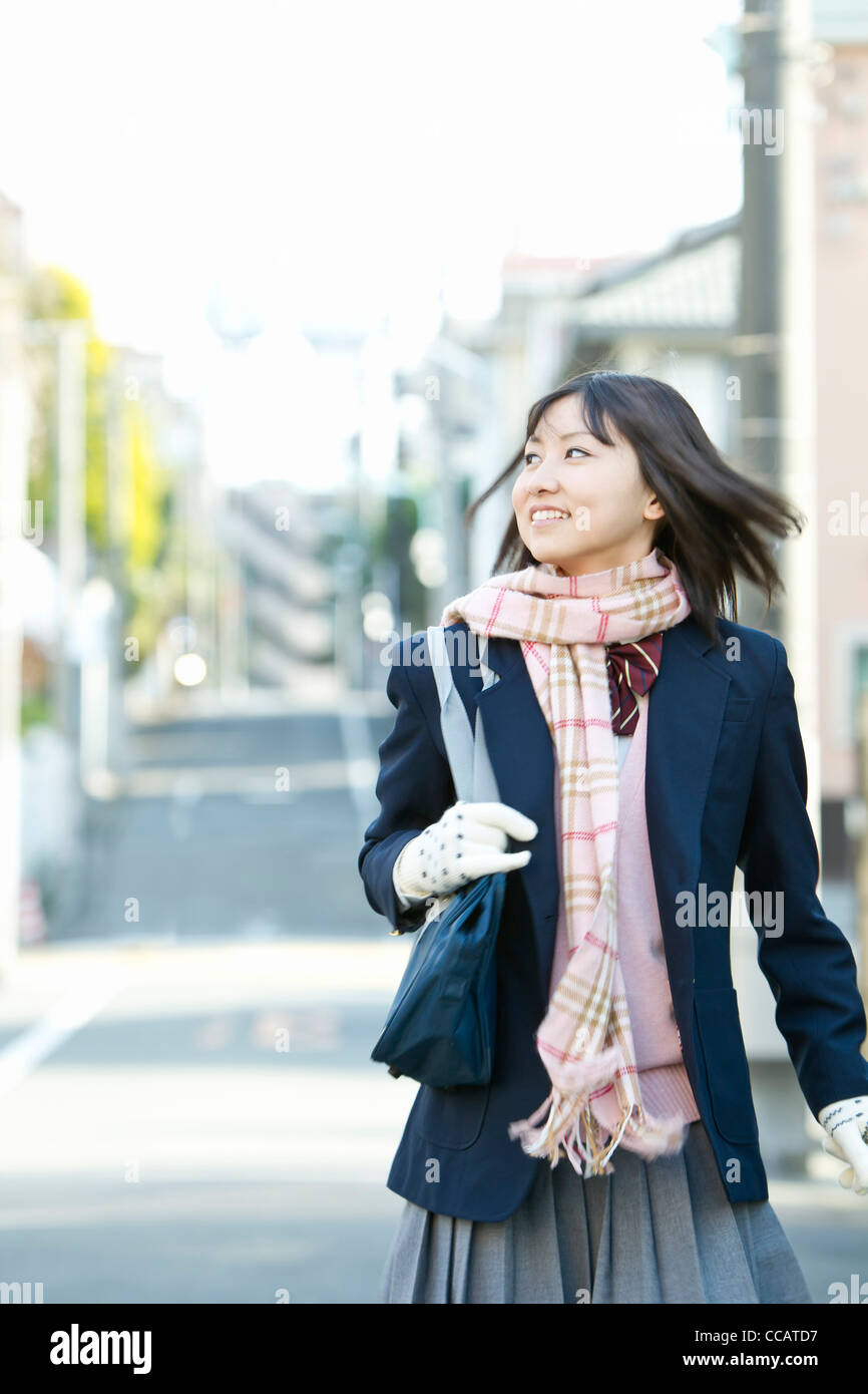 High school girl walking down the street Stock Photo