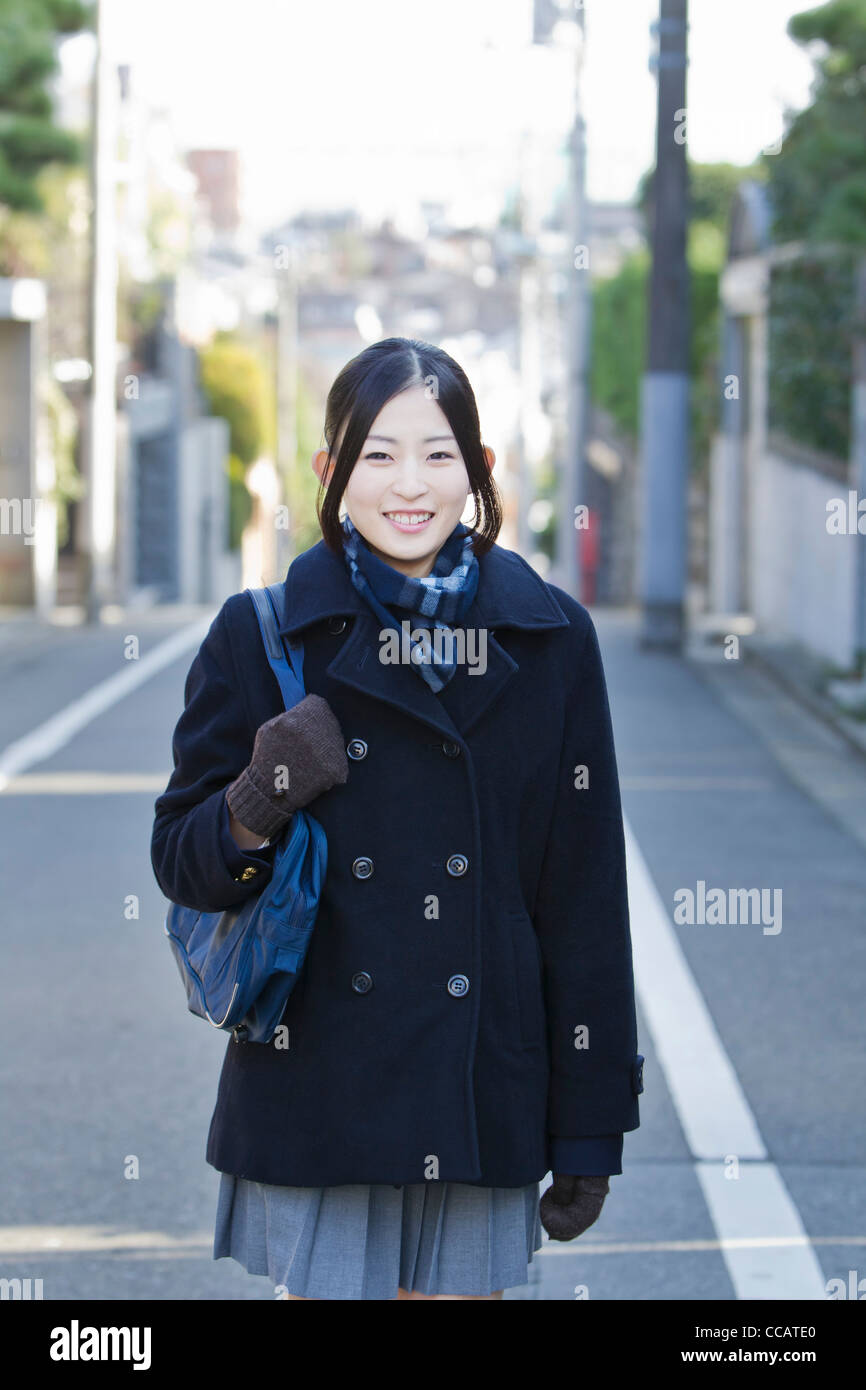 High school girl standing in the street Stock Photo