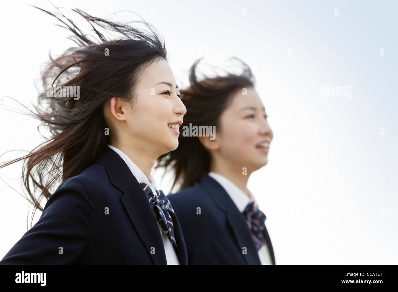 Two high school girls running Stock Photo