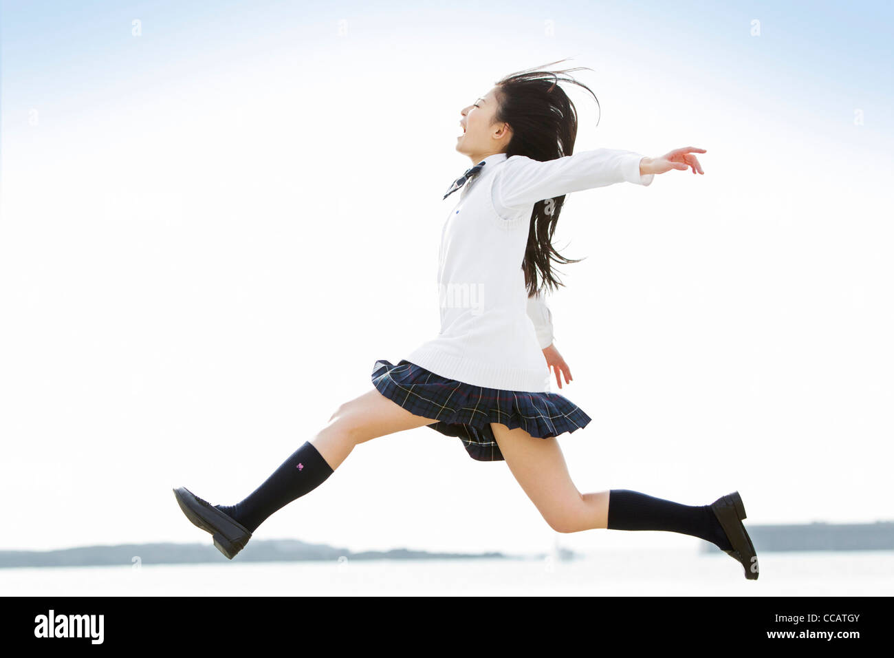 High school girl jumping Stock Photo
